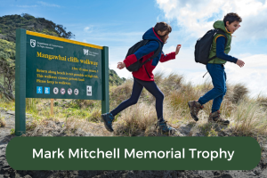 Two young people hike with the copy Mark Mitchell Memorial Trophy