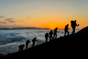 A group of people climb a mountain