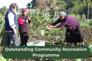 A group of women stand in a garden gathering food with the copy 'Outstanding Community Recreation Programme'