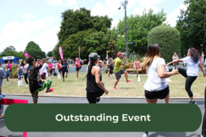 A group of people exercise outdoors with the copy overlaid 'Outstanding event'