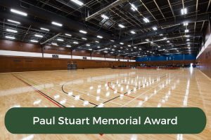 An image of a basketball court with the copy Paul Stuart Memorial Award