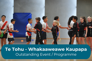 Children walk towards each other shaking hands with the copy Te Tohu - Whakaaweawe Kaupapa Outstanding Event/Programme Award