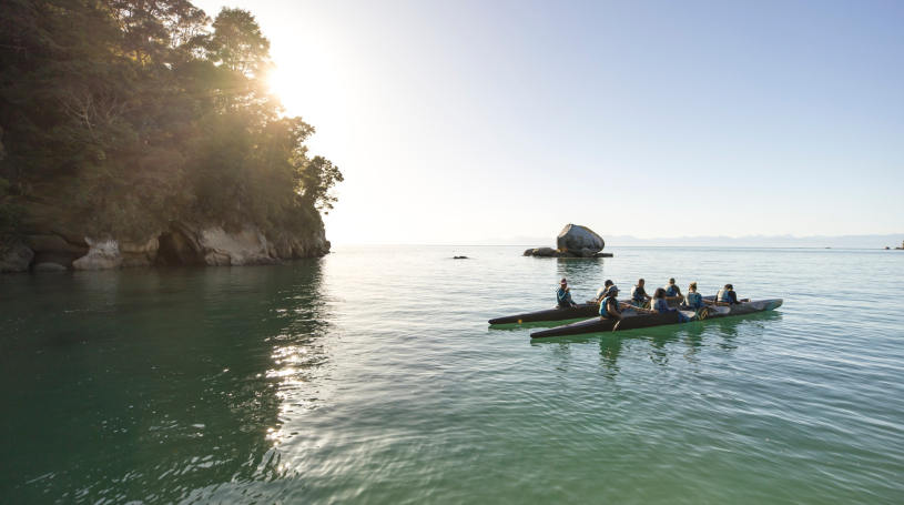 Image of a waka paddling out to sea