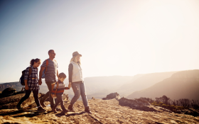 A family walk along the top of a mountain range